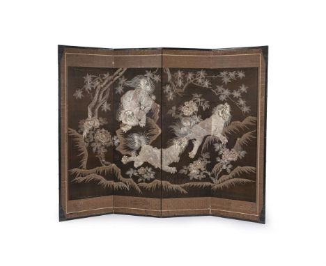 A Japanese Four-Fold Screen, embroidered on the brown silk ground with three Shishi playing amidst peonies, in metal-wrapped 