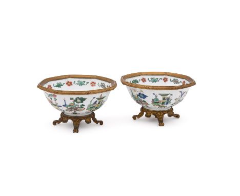 A pair of Chinese famille verte octagonal bowls, Kangxi, each of the eight panels richly decorated with the design of antiqui