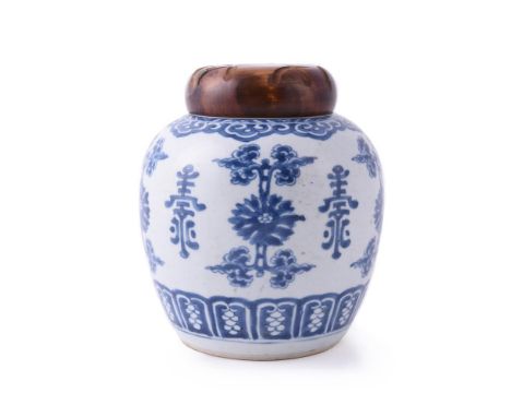 A Chinese blue and white ginger jar, Kangxi, painted with alternating flowerheads and shou symbols, the jar 17.5cm high, wood