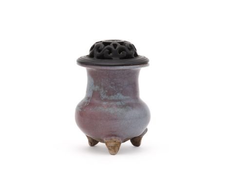 A Chinese jun glazed tripod censer, the globular body supported on three feet, and covered overall in a thick pale bluish-gre