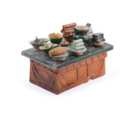 A Chinese sancai glazed pottery model of an altar table and offerings, Ming Dynasty, 15th or 16th century, the table with fla