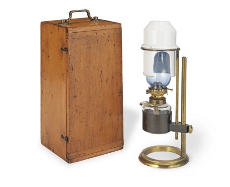 A Microscope Bench Lamp, English, circa 1880,complete with glass oil reservoir and chimney, on adjustable brass stand, with c