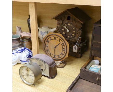 A Black Forest cuckoo clock, together with another octagonal faced timepiece, a Bakelite timepiece and another (4)