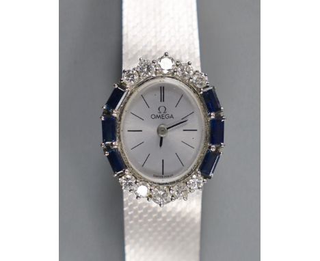 A lady's French 750 white metal Omega manual wind oval wrist watch, with sapphire and diamond set bezel, on integral Omega 75