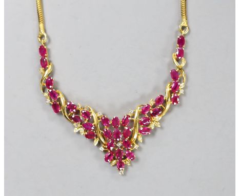 A modern Thai yellow metal, oval cut ruby and diamond chip cluster set necklace, 40cm, gross 22.6 grams.