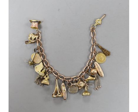 A 9ct charm bracelet, hung with assorted charms including two 9ct, silver and enamel, gilt metal and two gold coins gross wei
