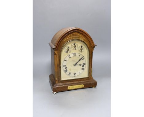 A George V inlaid walnut lancet shaped chiming mantel clock, with German movement and 15th July 1914 presentation plaque. 29c