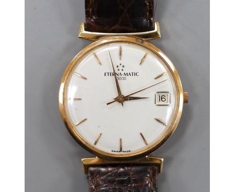 A gentleman's yellow metal Eterna-Matic wrist watch, with date aperture, on associated leather strap (lacking buckle), with b