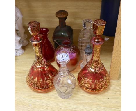 A pair of Bohemian gilded ruby glass decanters and stoppers, a Bohemian ‘millefiori paperweight’ stopper and associated decan