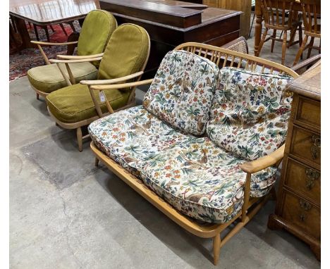 An Ercol light beech three piece lounge suite, settee length 134cm, width 75cm, height 75cm