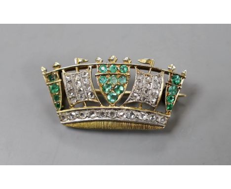 An early 20th century yellow metal, emerald and diamond set coronet brooch, 30mm, gross weight 4.4 grams.