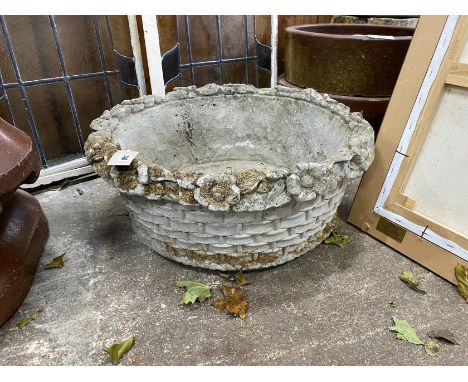 A circular reconstituted stone basket weave garden planter with floral rim, diameter 60cm, height 23cm