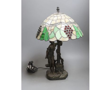 A figural table lamp with Tiffany style shade 47cm