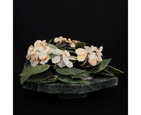 A 20th century Chinese carved spinach jade and soapstone bonsai tree raised on a naturalistic marble base. H.27cm