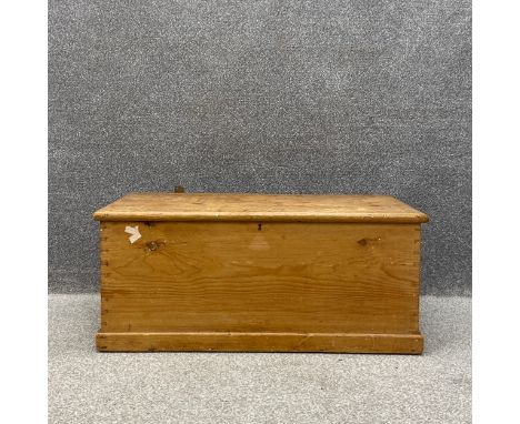 A Victorian pine trunk having a moulded top with iron hinges and handles on a plinth base. (Lid unattached as seen). H.43 W.1