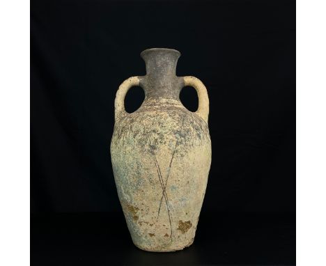 A large Roman style terracotta twin handled olive jar or amphora hand painted with geometric patterns on a round foot. H.62cm