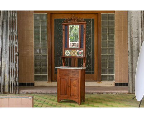A SLIM PERANAKAN STYLE MIRRORED HALLSTAND
With pierced and carved foliate cresting and three floral tiles over a single shelf