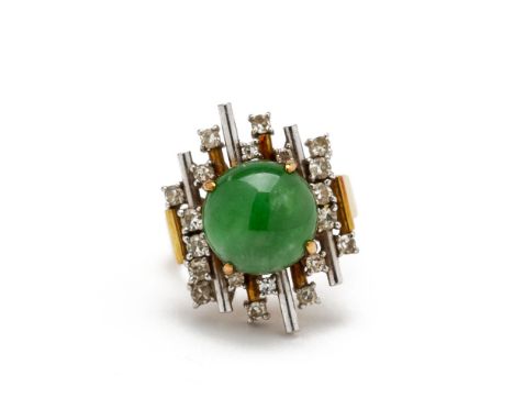 A JADE AND DIAMOND RING
In two colour gold, with a circular jade cabochon in an abstract diamond set mount, the shank with Ch