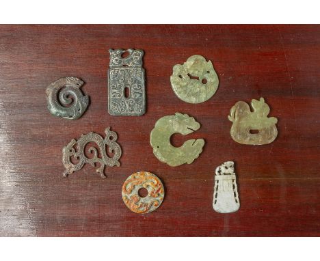 EIGHT ARCHAIC STYLE JADE PENDANTS AND CARVINGS Including dragons, bi disk etc. The largest 8cm long Condition: For a conditio