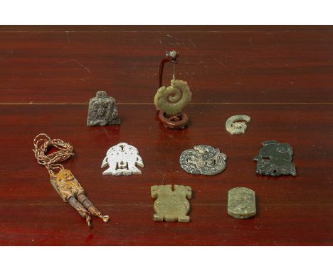 A GROUP OF ARCHAIC STYLE JADE PENDANTS Variously carved with mythical creatures and other decoration Largest 7cm long Conditi