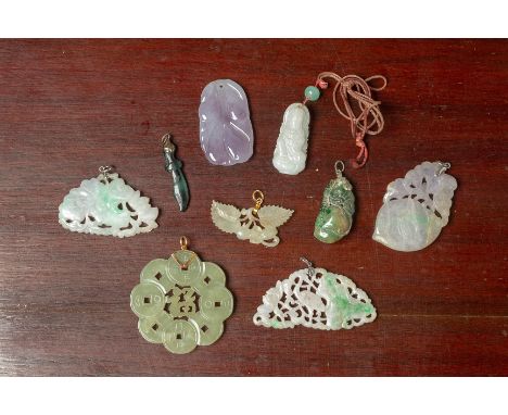 A SMALL GROUP OF CARVED AND PIERCED JADE PENDANTS
Mostly with foliate decoration and with metal mounts, one example of Guanyi