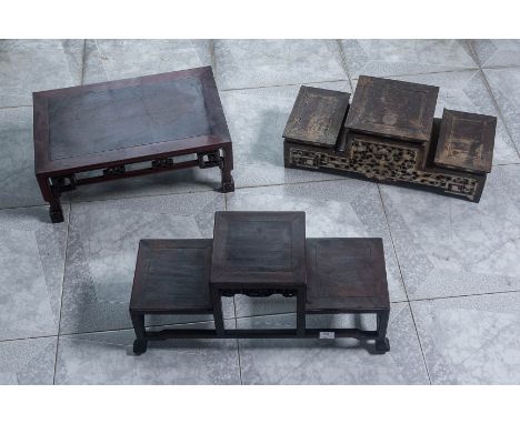 THREE CARVED HARDWOOD STANDS
One rectangular example with carved and pierced apron on scroll feet; one three tiered example w
