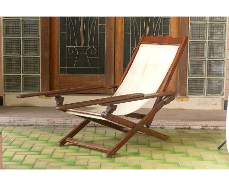 A PLANTER STYLE RECLINING ARMCHAIR
With canvas seat and extending armrests
92cm H x 67cm W x 126cm D (unextended)
Condition: 