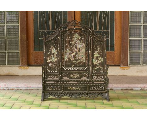 A MOTHER OF PEARL INLAID HARDWOOD TABLE SCREEN Arched design and decorated with figures amongst pagodas with pierced and foli
