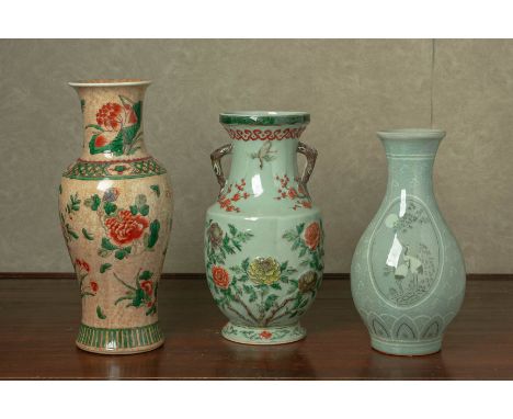 A GROUP OF ORIENTAL CERAMIC VASES
Comprising a moulded twin handled baluster vase decorated with flowers, a famille verte bal