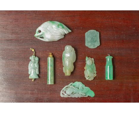 A GROUP OF JADE CARVINGS AND PENDANTS Including two cylindrical pendants, three figural examples and a fish with lotus exampl