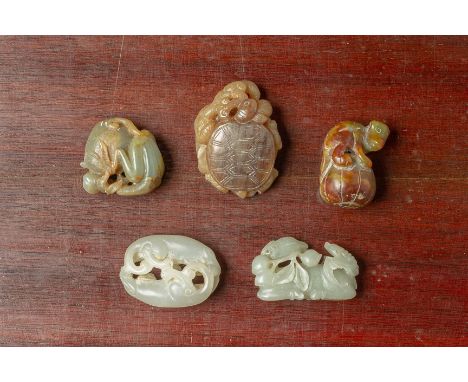 A GROUP OF FIVE JADE CARVINGS
Comprising a tortoise with a snake perched on a lotus leaf, a deer with a bat upon its back, a 