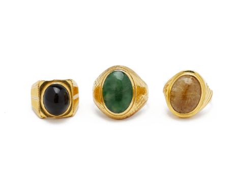 THREE CABOCHON SET LARGE GOLD RINGS
Comprising a jade example in 22k; a quartz example indistinctly marked, probably '850'; a