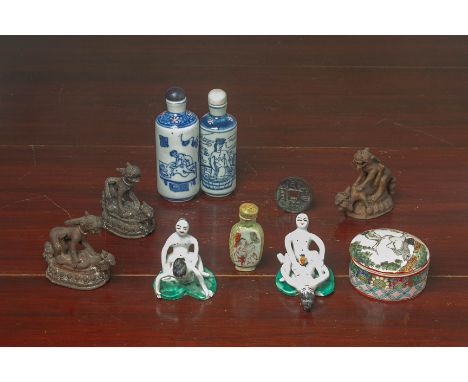 A GROUP OF EROTIC THEMED PORCELAIN ITEMS
Comprising a pair of models of amorous couples, a circular box of cover with erotic 
