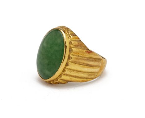 A JADE RING
Set in 22k gold , the oval jade cabochon within a fluted setting, indistinctly marked '916'
US ring size 9
12.2g
