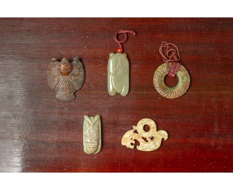 A GROUP OF FIVE ARCHAIC STYLE JADE CARVINGS Comprising a spirally fluted disk, two cicadas, a winged animal and a stylised dr