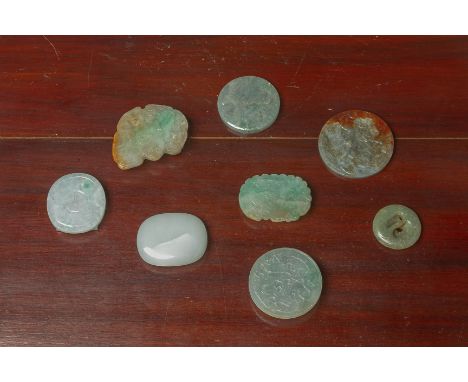 A GROUP OF EIGHT JADE BELT BUCKLES AND DISKS One modelled as a bat, variously carved in shallow relief Largest 8cm wide Condi