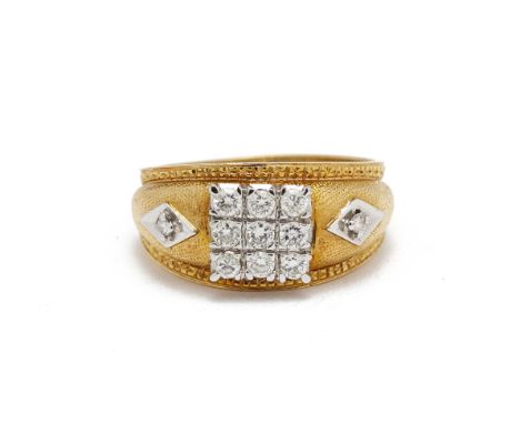 A DIAMOND RING
In 22k gold, set with a panel of 12 round brilliant cut diamonds, and two further diamonds to each shoulder, t