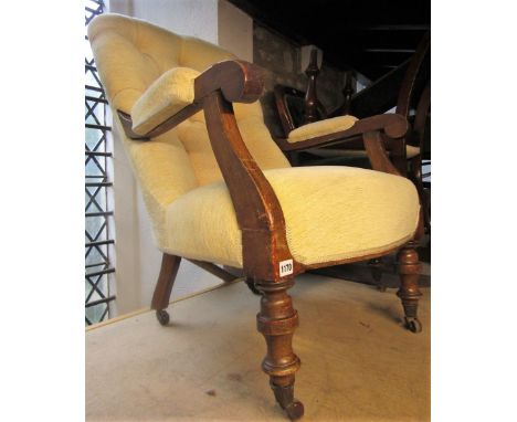 A Victorian walnut drawing room chair with upholstered seat and button back raised on turned supports and castors, together w