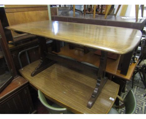 An Ercol elm Windsor refectory table with shaped supports together with four Windsor hoop back dining chairs with original pa