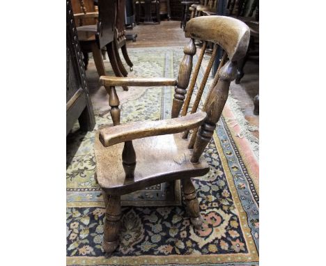 A Georgian ashwood child's stick back elbow chair, the seat in sycamore, overall height 65cm 