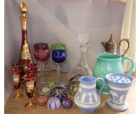 A mixed lot to include a cut glass claret jug and ships decanter, together with various coloured cut glass goblets and paperw