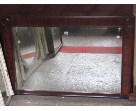 A William IV overmantle mirror of rectangular form, the flamed mahogany veneers with bulls eye panels, 115 cm max,  together 