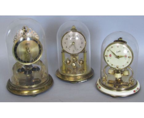 Three vintage brass torsion clocks all under glass domes