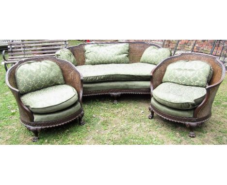 A good quality Edwardian three piece bergere suite, the sofa with enclosed back and concave outline, with geometric repeating