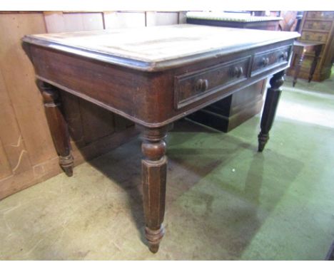 A Victorian mahogany writing table of rectangular form with moulded outline and rounded corners over two frieze drawers raise