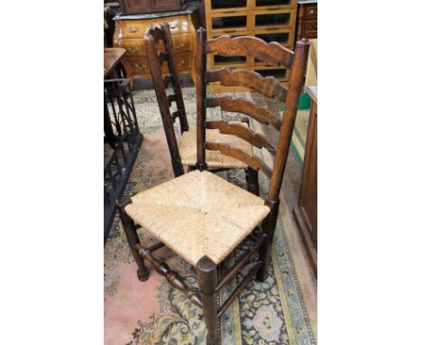 A harlequin set of six Georgian ashwood ladder back dining chairs of usual form, all with rush seats