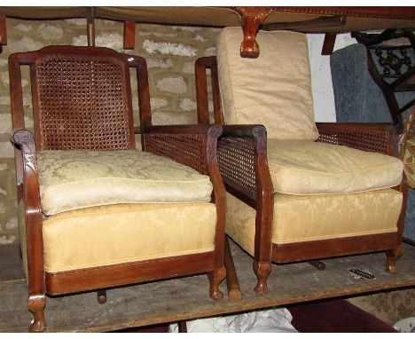 A Bergere three seat sofa, with shaped outline and scrolled arms, cream ground floral patterned upholstered seat, loose feath