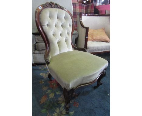 A Victorian ladies drawing room/nursing chair with serpentine upholstered seat and button back within a walnut showwood frame