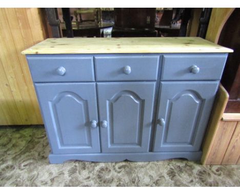 A pine kitchen dresser with stripped top and painted base enclosed by three arched fielded panelled doors and three frieze dr