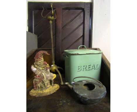 A 19th century cast iron door stop in the form of Mr Punch, a vintage green enamelled bread bin and a brass stand on tripod b